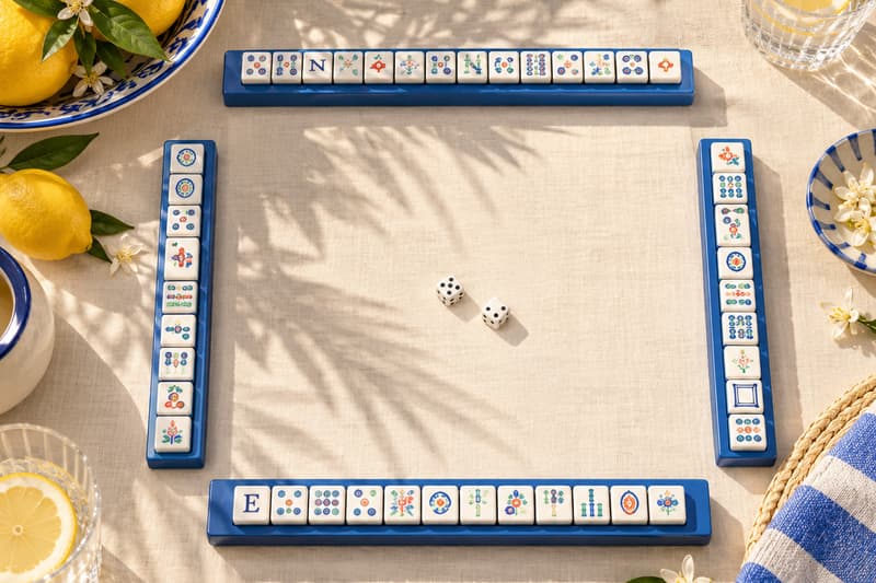A mahjong game being set up, seen from above, with racks, the wall, and dice