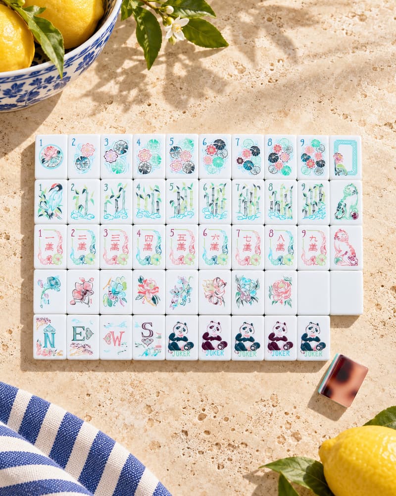The Amalfi Set laid out in rows on a sunny stone table, with watercolor-style faces