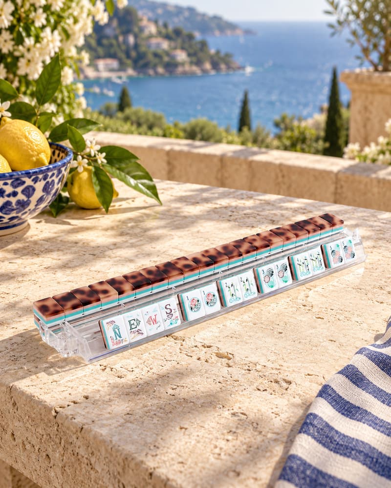Amalfi Set tiles with tortoiseshell backs standing in an acrylic rack by the sea