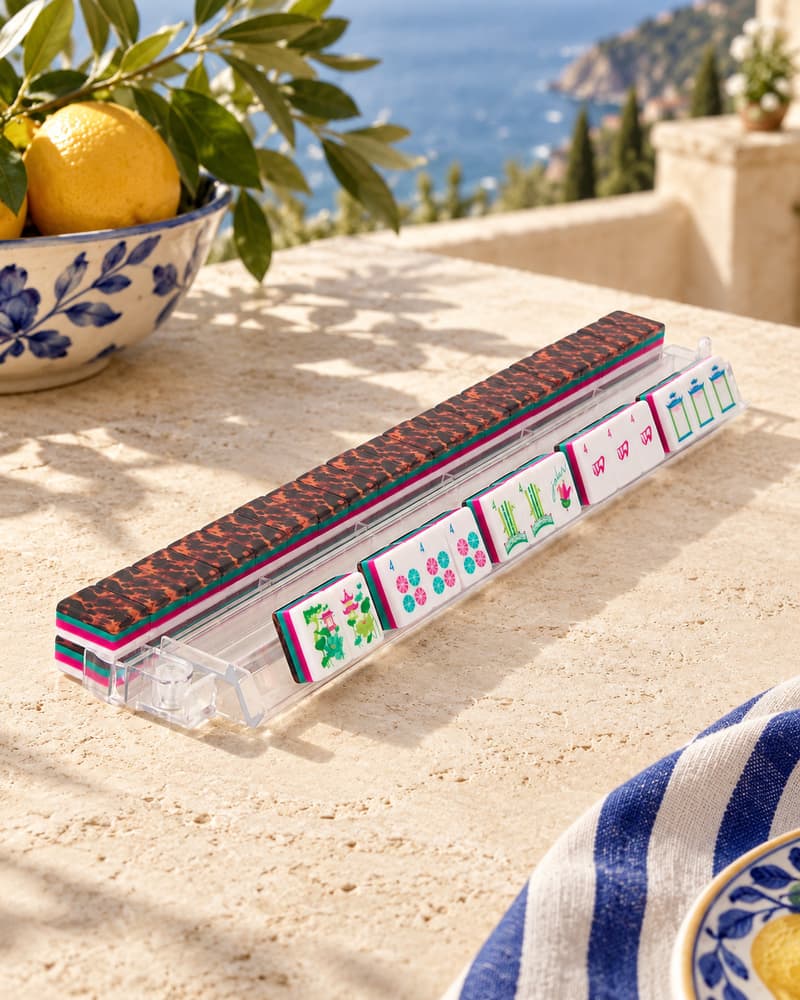 Bougainvillea Set tiles with tortoiseshell backs standing in an acrylic rack by the sea