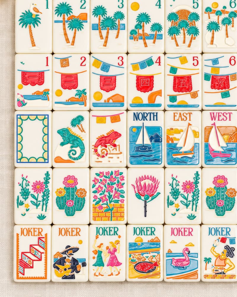 Close-up of Cabo Set tile faces with banners, iguanas, sailboats, cactus flowers and beach jokers
