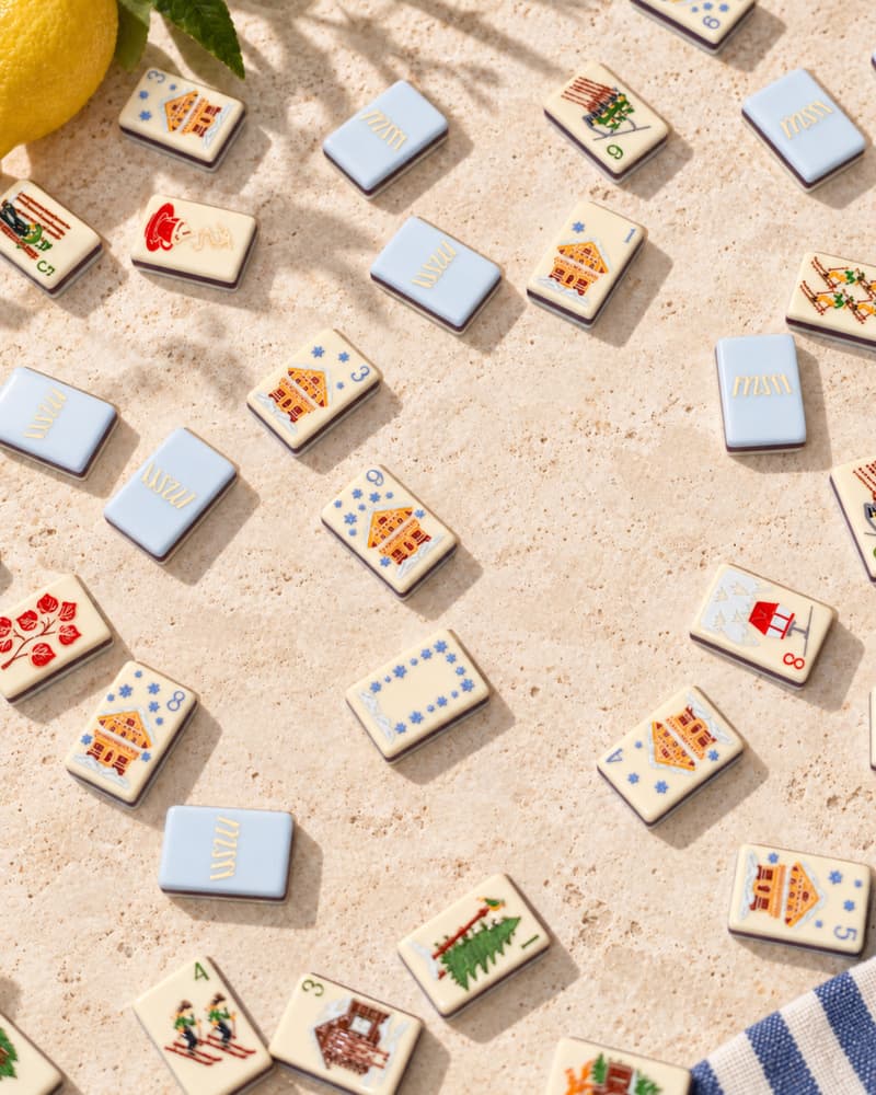 Chalet Set tiles scattered on a sunny stone table, with icy blue backs and alpine faces