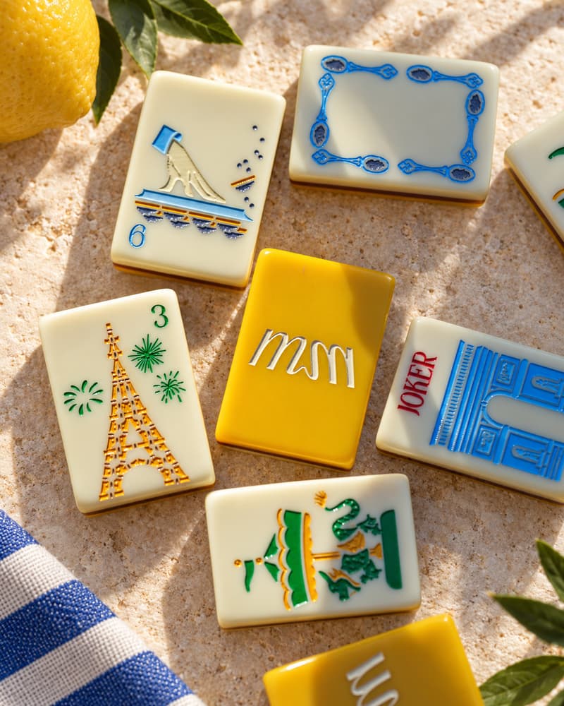 Montmartre Set tiles on a sunny stone table, with Eiffel Tower faces and a golden yellow back