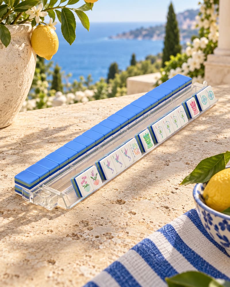 Mykonos Set tiles with cobalt backs standing in an acrylic rack by the sea
