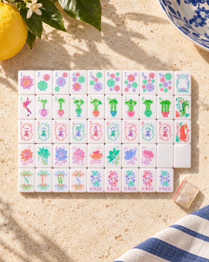 The Perla Set laid out in rows on a sunny stone table, with pastel floral faces