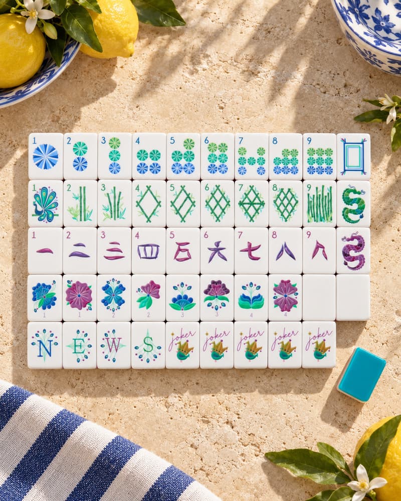 The Portofino Set laid out in rows on a sunny stone table, with blue, purple and green faces
