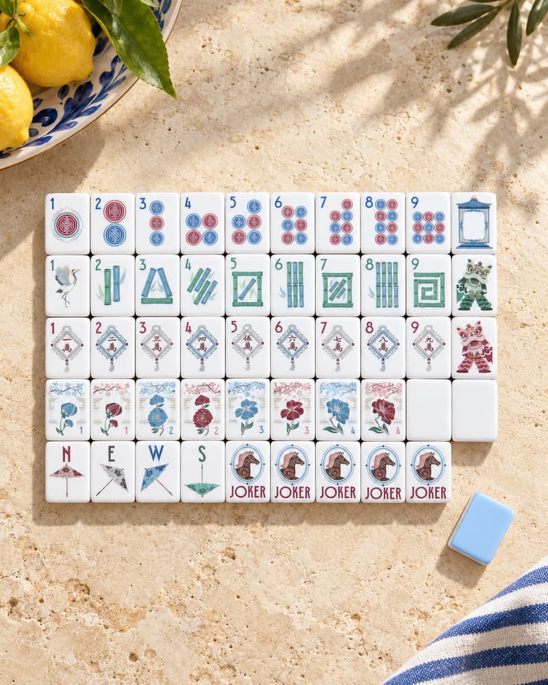 The Riviera Set laid out in rows on a sunny stone table, with sky-blue tile backs