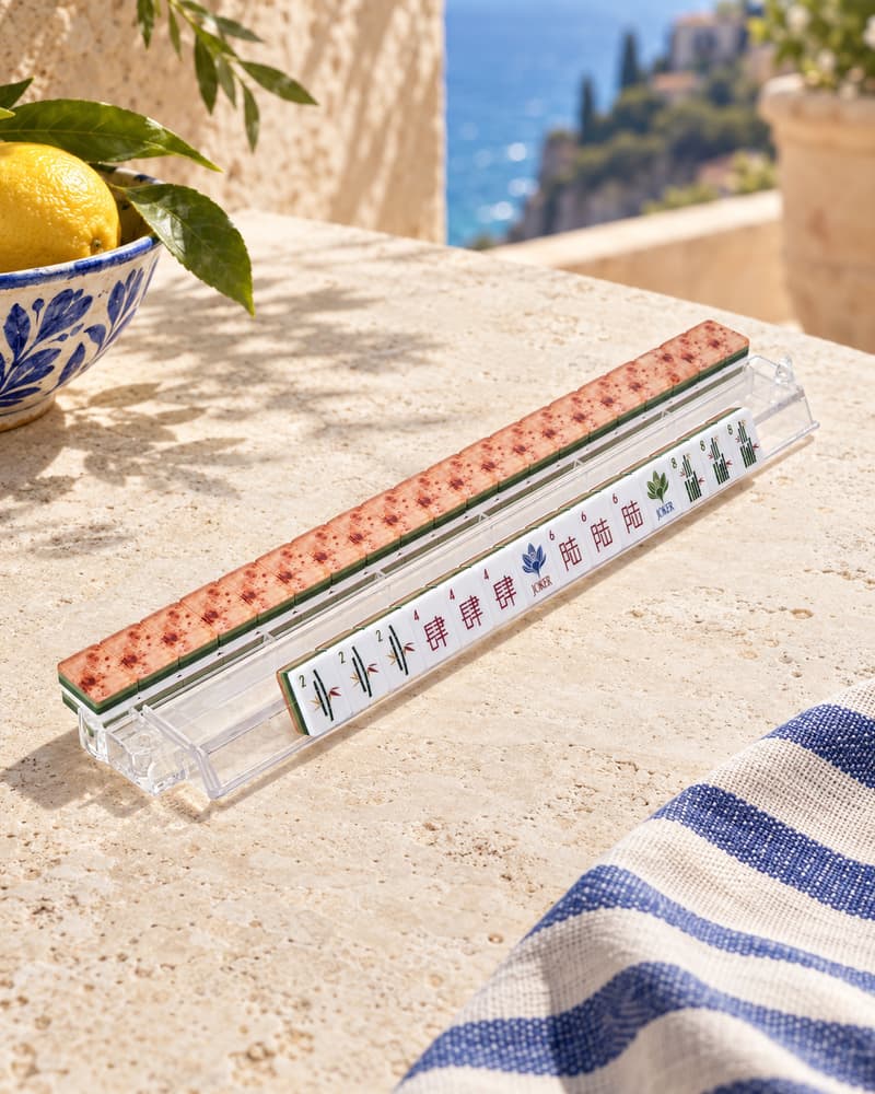 Villa Set tiles with speckled terracotta backs standing in an acrylic rack by the sea